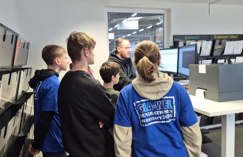 Schülergruppe und Mitarbeiter Laserprogrammierung